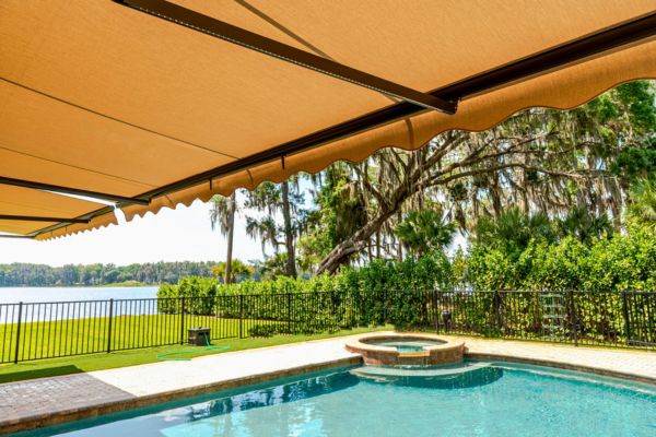 Tan Retractable Awning underside of tan retractable awning overlooking a pool