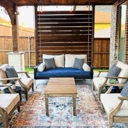 Backyard with beige patio chairs and sofas decorated with blue pillows