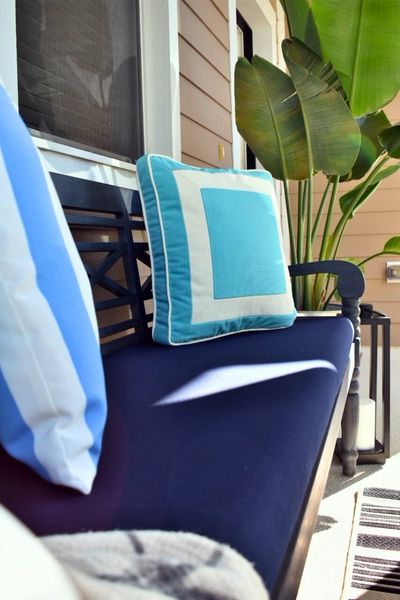Porch Oasis with Outdoor Bench Outdoor bench with blue cushion and light blue pillows