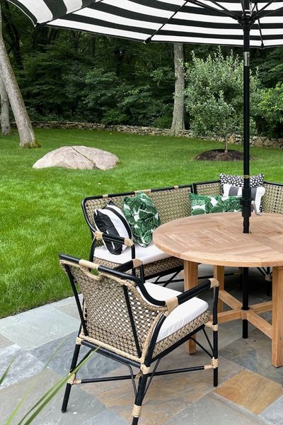 Backyard Relaxation with Umbrella Backyard patio with outdoor furniture and black and white umbrella