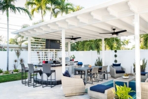 white pergola with ceiling fans and outdoor furniture underneath