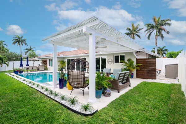 Aria Renaissance Pergola White lattice style pergola near pool
