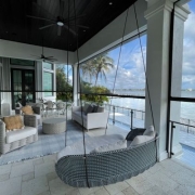 Second level patio with outdoor furniture and shade screen.