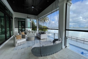 Second level patio with outdoor furniture and shade screen.