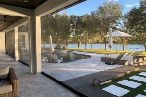 Porch shade screen facing outdoor pool and furniture