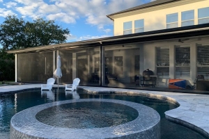 Poolside shade screen with two white pool chairs