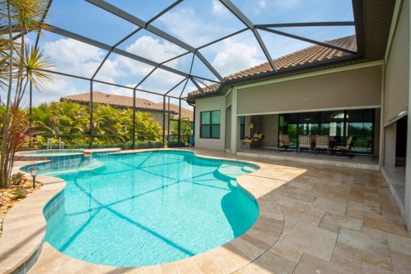 Pool Shadescreen Caged outdoor patio with pool and tan shade screen